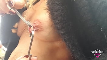 Busty beauty enjoys outdoor nipple stretching with hooks